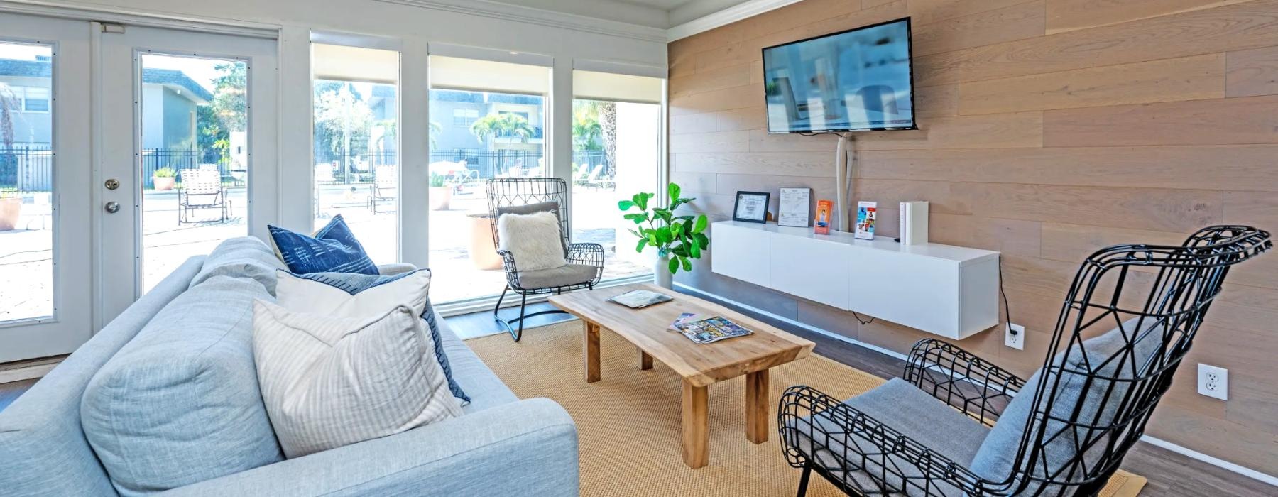 a living room with a tv couch and a table