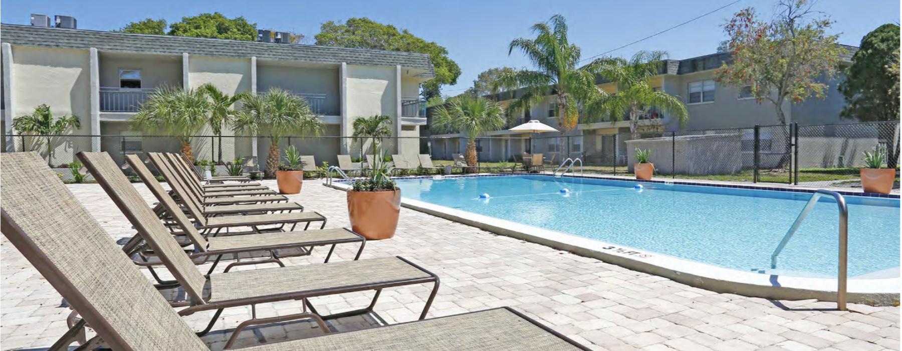 a pool with chairs around it